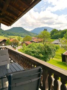 a balcony with a bench and a view of the mountains at Matheishof in Ruhpolding