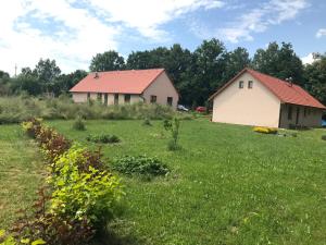 una granja con dos edificios y un campo de césped en Apartmán Karhule (pod Blaníkem), 