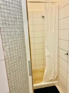 a shower with a shower curtain in a bathroom at City Rooms in Budapest
