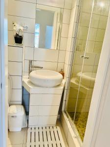 a bathroom with a sink and a shower at City Rooms in Budapest