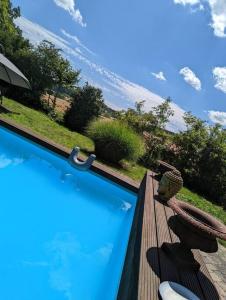 a swimming pool with a bench and an umbrella at WOW magisches Luxus Glamping mit Pool im Paradies in Bad Salzdetfurth