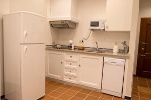 a kitchen with a white refrigerator and a sink at Garza Imperial - Puente del Rey I in El Rocío +2 photos