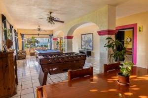 a large living room with a table and a ceiling fan at Casa María Resort in Bucerías