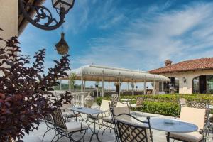 a patio with tables and chairs and a gazebo at Relais Le Due Matote in Bossolasco