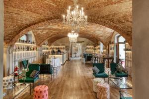 a room with a brick wall and a chandelier at Relais Le Due Matote in Bossolasco