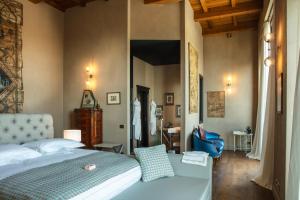 Schlafzimmer mit einem Bett mit blauer Tagesdecke und einem Zimmer in der Unterkunft Relais Le Due Matote in Bossolasco