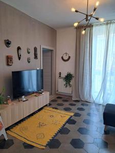 a living room with a large flat screen tv at CINQUE TORRI AFFITTACAMERE in Osimo