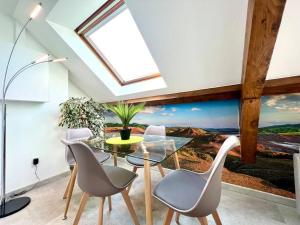 a dining room with a table and chairs and a window at Natural Suite - Proche Gare - 4P in Belfort