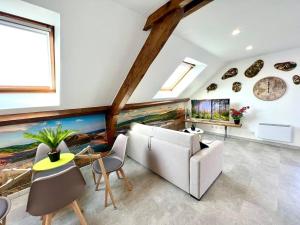 a living room with a large painting on the wall at Natural Suite - Proche Gare - 4P in Belfort