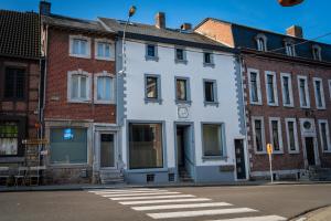 a white building on the corner of a street at Cheval Blanc - Holiday Rental in Aubel