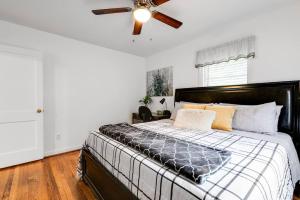 a bedroom with a bed with a ceiling fan at RF Central location w fenced backyard FIRE-PIT in Richmond