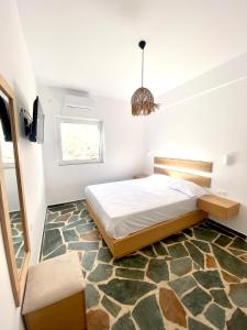 a bedroom with a large bed and a large rug at Villa Acta in Kithnos