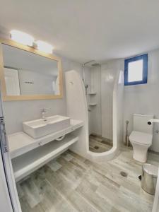 a bathroom with a sink and a toilet at Villa Acta in Kithnos +18 photos