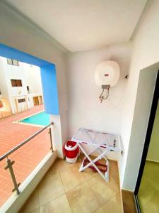 a balcony with a swimming pool and a basketball hoop at Comfort apartment, with nice terrace (2min to sea) in Aourir