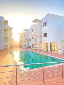 a swimming pool in the middle of a building at Comfort apartment, with nice terrace (2min to sea) in Aourir