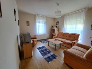 a living room with a couch and a tv at Apartment Keszeg-2 by Interhome in Balatonkeresztúr