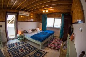 a bedroom with a bed in the middle of a room at Skyrock Dahab in Dahab