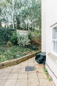 an outside view of a yard with a building and a window at Stylish Open Plan City Apartment in Bath