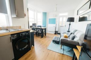 uma cozinha e sala de estar com um sofá e um fogão em Stylish Open Plan City Apartment em Bath