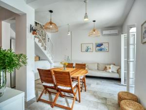 a dining room with a wooden table and chairs at House Gajarda in Rab