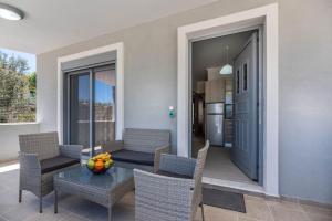 a living room with a table and chairs and a kitchen at Extreme House in Archangelos