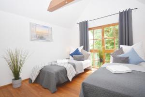 a bedroom with two beds and a window at NUE12-RI Apartment in Zirndorf in Zirndorf