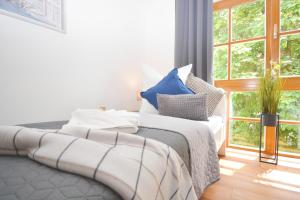 a bedroom with a bed and a large window at NUE12-RI Apartment in Zirndorf in Zirndorf