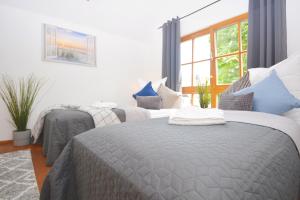 a bedroom with two beds with blue and white pillows at NUE12-RI Apartment in Zirndorf in Zirndorf