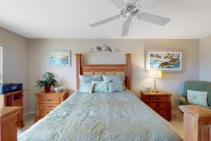 a bedroom with a bed and a ceiling fan at Sea-Renity, Unit H-205 in Naples