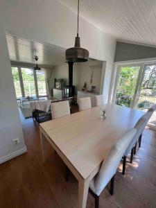 a dining room with a table and white chairs at Trevligt hus med vacker omgivning in Stockholm +12 photos
