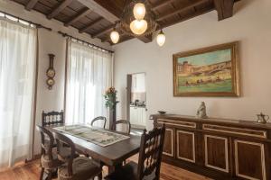 a dining room with a table and a painting on the wall at Boutique Ponte Vecchio in Florence