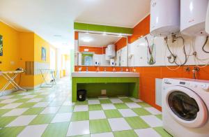 a colorful laundry room with a washer and dryer at Guest house "Golden Gate" in Kyiv