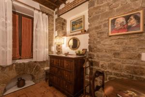a stone walled bathroom with a stone fireplace at Boutique Ponte Vecchio in Florence +24 photos