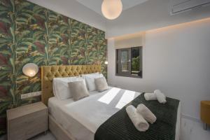a bedroom with a large bed with a floral wallpaper at Vert House near The Beach in Agia Pelagia