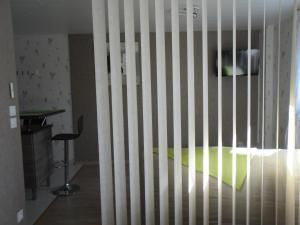 a room with a bed with a wooden fence at L'Escale Des Voyageurs in Chalindrey