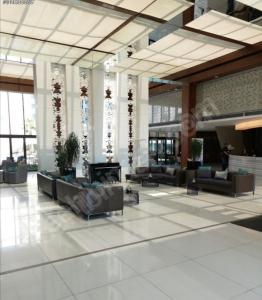 a lobby with couches and chairs in a building at İstanbul Lüks daire in Istanbul