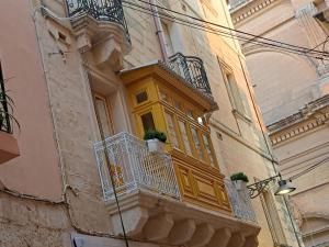 a yellow door on the side of a building at Ta' Wenzu in Birgu