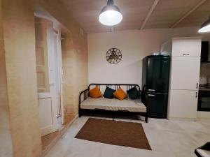 Habitación pequeña con cama y nevera. en Ta' Wenzu, en Birgu