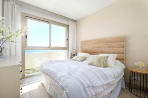 a bedroom with a bed and a large window at Luxury frontline apartment in Aria Resort with Spa and Fitness in Fuengirola +24 photos