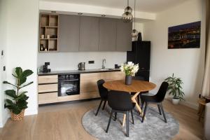 a kitchen with a table and chairs in a room at Belgrade Waterfront Sunshine apartment in Belgrade