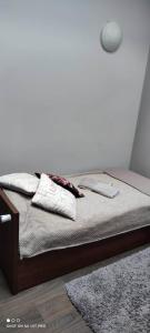 a bed with two pillows on it in a room at Hotelik Kościerzyna in Kościerzyna