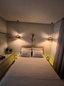a bedroom with a large bed with lights on it at Supreme Malibu Suit in Alexandroupoli
