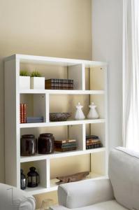 a white book shelf in a living room at Lisbon Surf + Beach Villa in Costa da Caparica