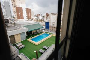 a view of a swimming pool from a building at San Nicolas Plaza in San Nicolás de los Arroyos