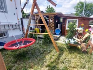 a backyard with a swing and a house at Apartment Garden-1 by Interhome in Karl
