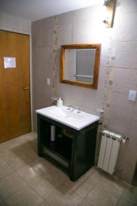 a bathroom with a sink and a mirror at Cabañas Dulce Sofía in San Carlos de Bariloche