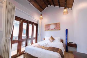 Postel nebo postele na pokoji v ubytování The Poplar Resort Phú Quốc