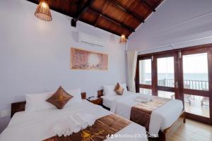 Postel nebo postele na pokoji v ubytování The Poplar Resort Phú Quốc