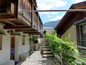 a stairway leading up to a house with mountains in the background at Chalet Tschingeli by Interhome in Niedergampel