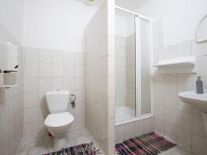a white bathroom with a toilet and a sink at Apartment Kačenka-4 by Interhome in Desná